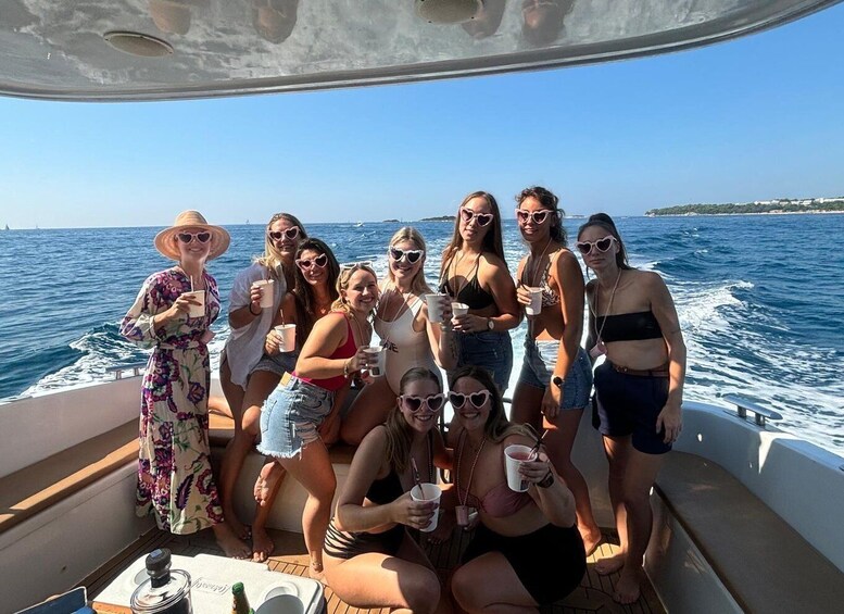 A group of people on a boat with the ocean and a distant shoreline in the background. 3