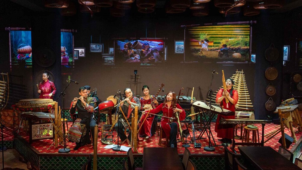 A traditional music performance with musicians playing various instruments on a stage. 4