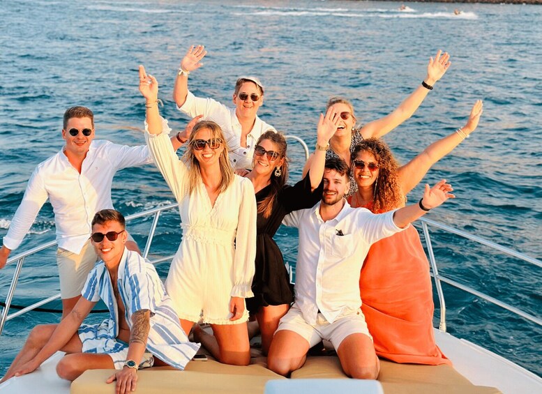 A group of people on a boat with the ocean in the background. 4