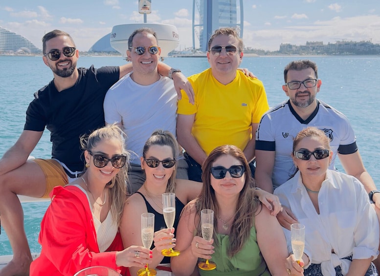 A group of people on a boat with a city skyline in the background. 2