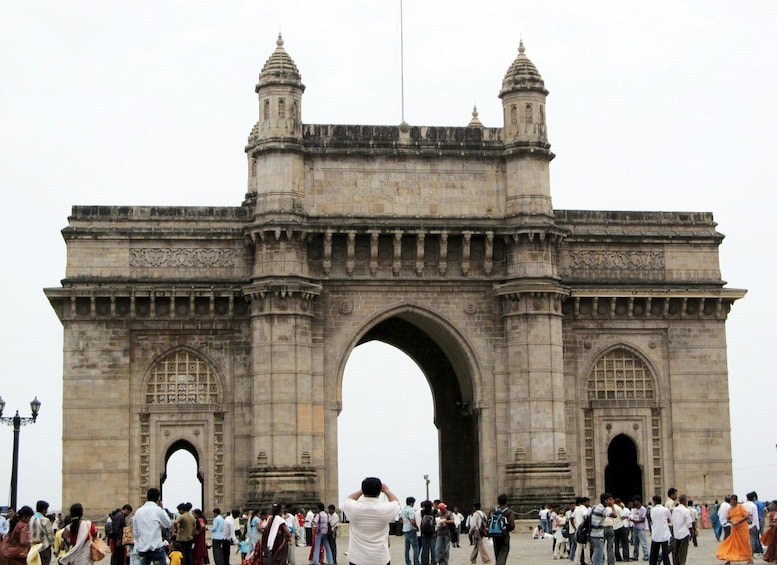 The Gateway of India with two towers and a large archway. 1