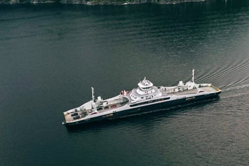 A large, white, multi-deck ship on calm water. 4