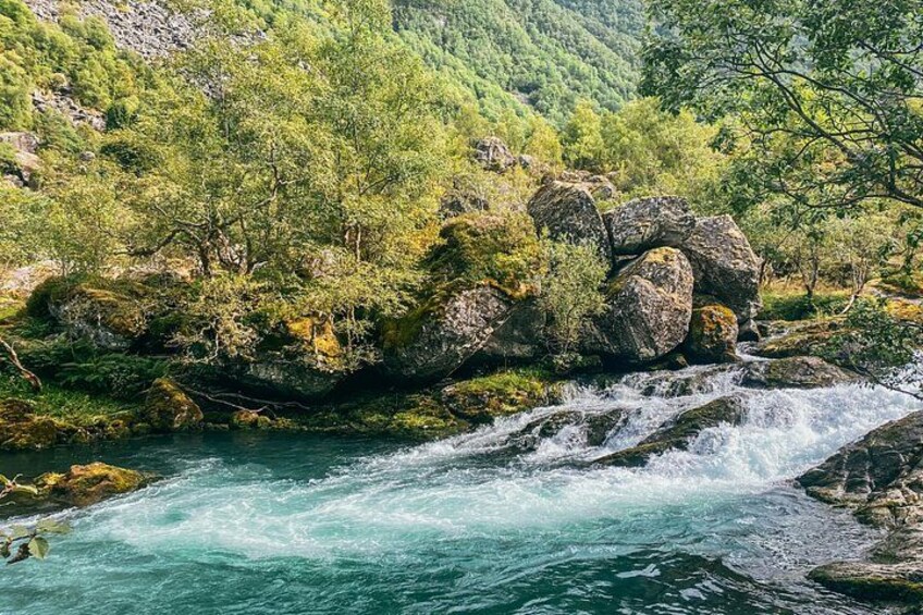 A river flowing through a rocky landscape with lush greenery. 3