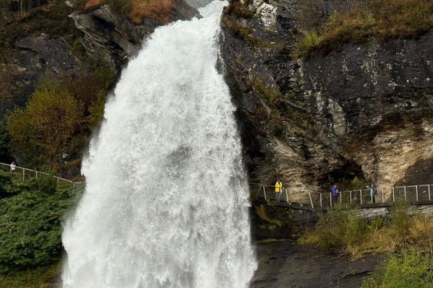 A large waterfall cascading down a rocky cliff. 4