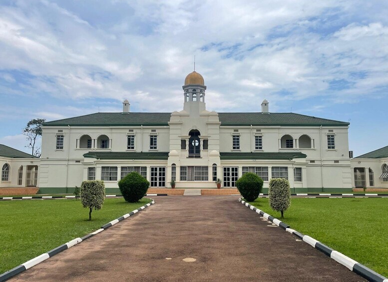 A large, white colonial-style building with a central dome and a symmetrical facade. 4