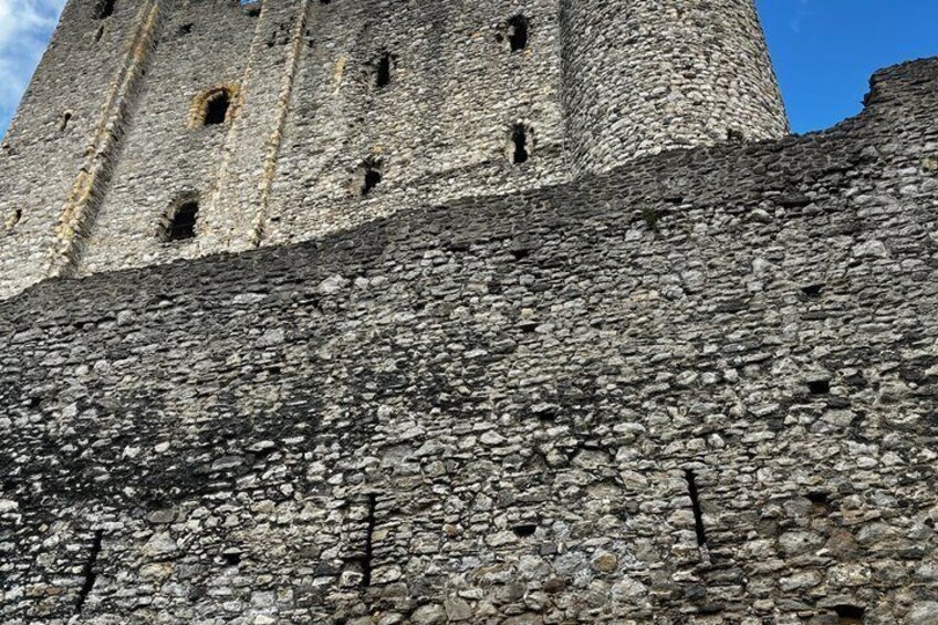 A stone tower with multiple openings and a rough-textured facade. 4