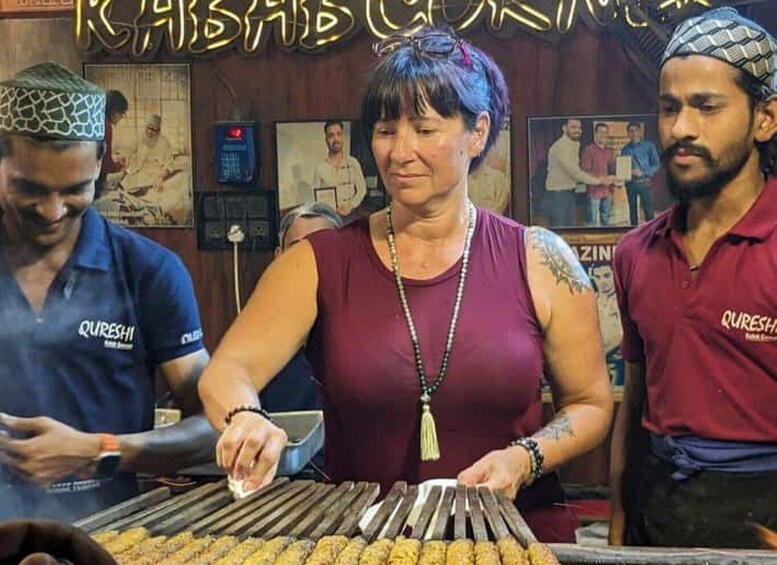 A person grilling food outdoors, with a grill and food visible. 5