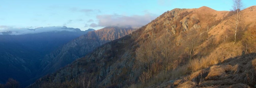 A mountainous landscape with rocky terrain and sparse vegetation. 5