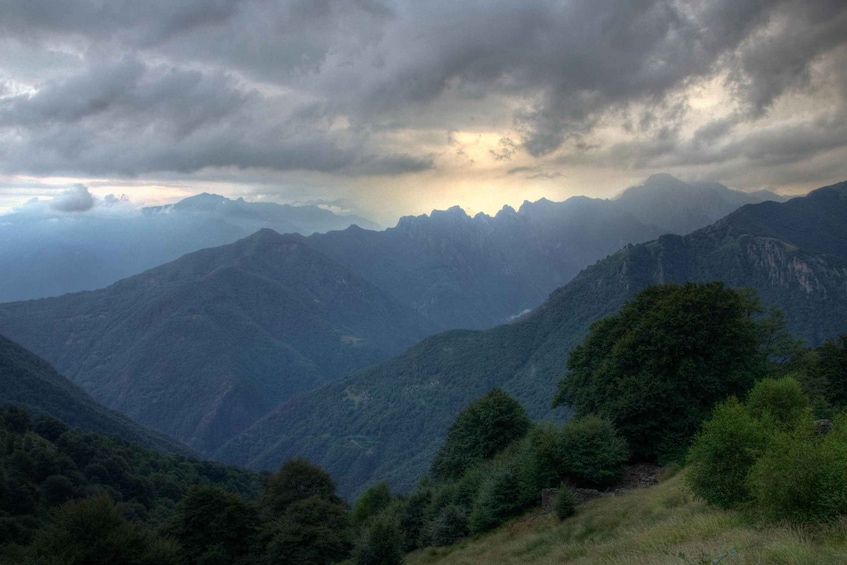 A mountainous landscape with dense forests and rugged terrain. 3