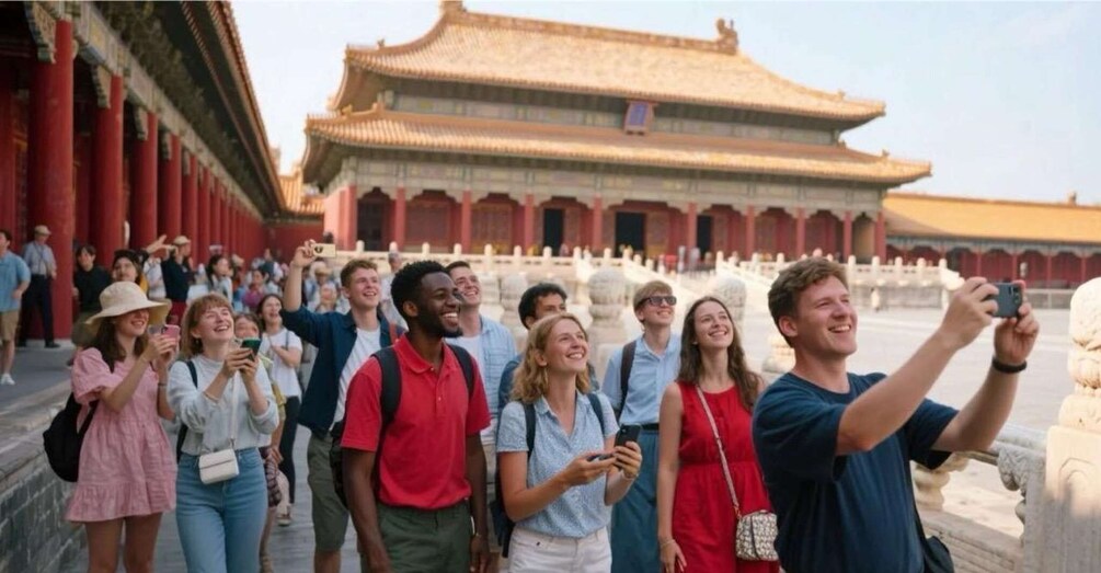 A group of tourists taking photos in front of a traditional Chinese building with red columns and a tiled roof. 1
