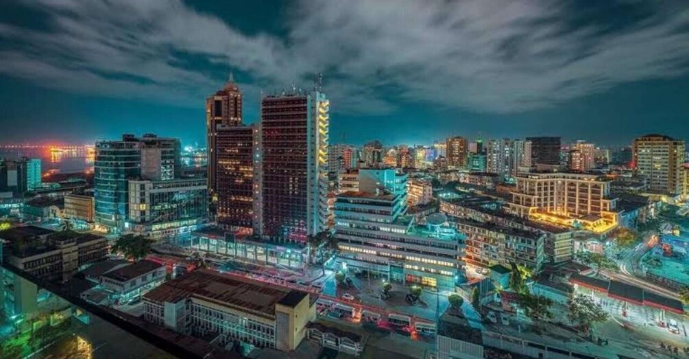 A cityscape at night with illuminated buildings and a river. 4