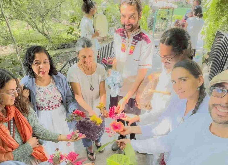 A group of people outdoors, some holding flowers. 2