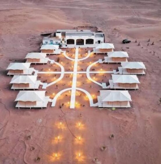A desert resort with multiple tents arranged in a symmetrical pattern, connected by a central pathway. 2