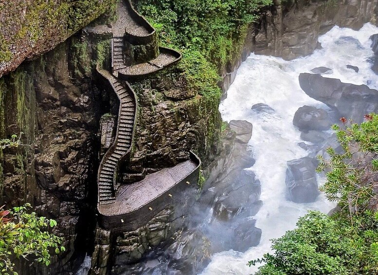 A steep, rocky waterfall with a serpentine stone staircase. 1