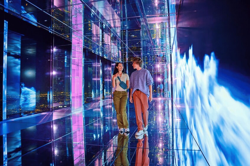 A modern glass building with a reflective interior and a water feature. 3