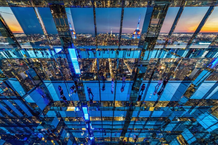 A high-rise building with a glass facade reflecting the cityscape below. 4