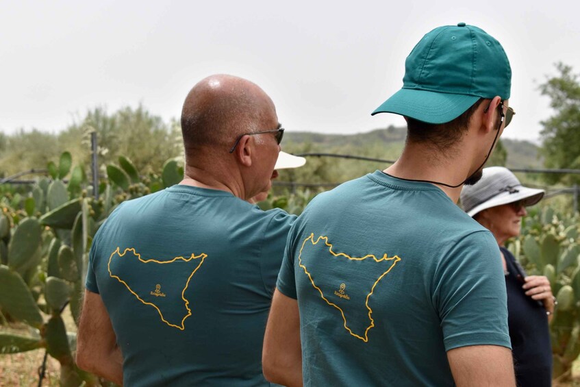 Two people wearing matching t-shirts with a map outline and the word 'Longevity' on the back. 2