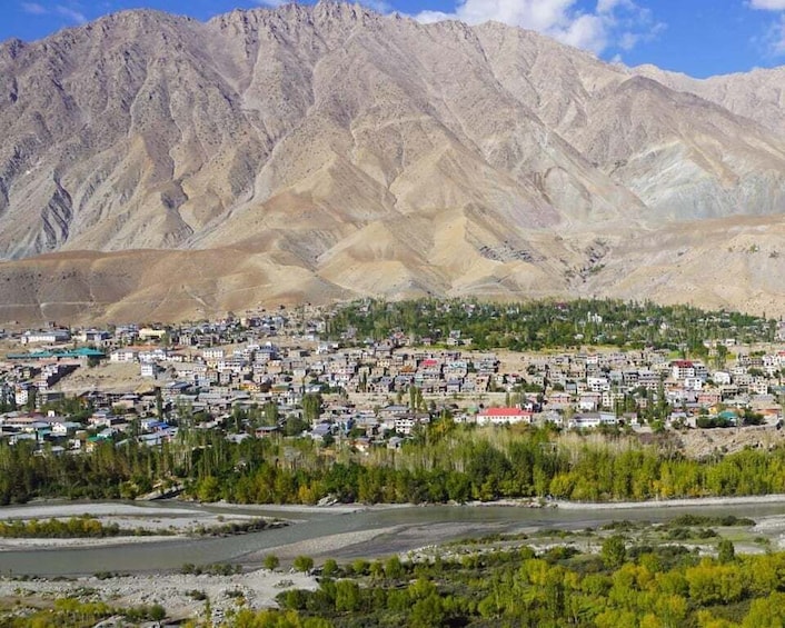 A town nestled in a valley with mountains in the background. 4