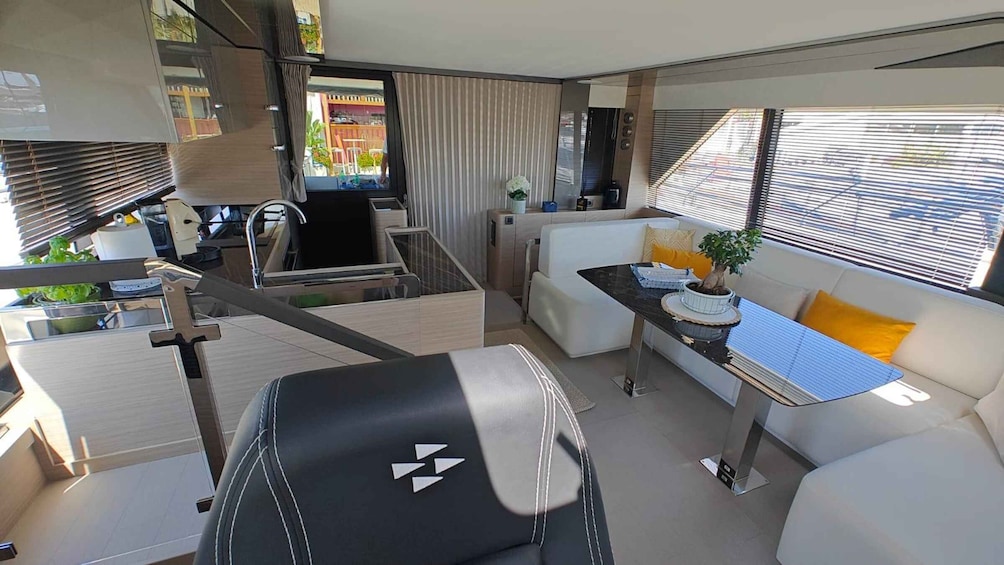 A modern interior with a sofa, a dining table, and a kitchen area. 5