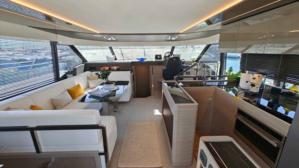 A modern interior with a white sofa, a dining table, and a kitchen area with appliances. 3
