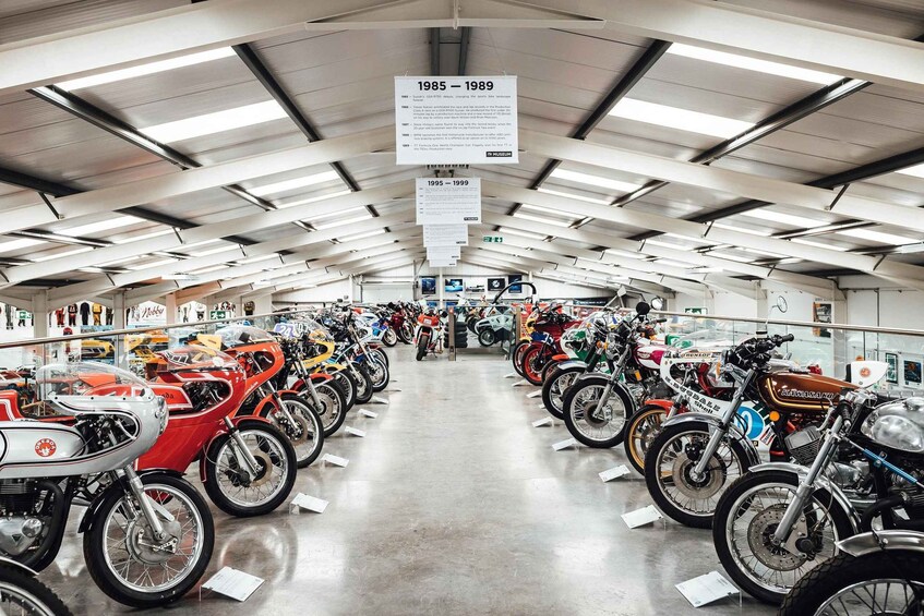 A museum with motorcycles on display, labeled with years 1985-1989 and 1995-1999. 5