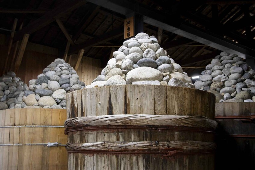 A wooden structure with large stone piles and woven baskets. 3