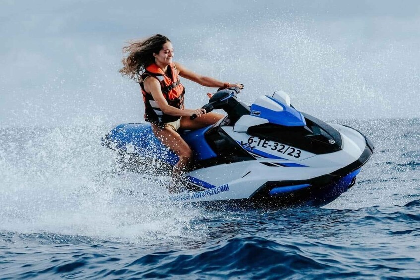 A person riding a jet ski on water. 4