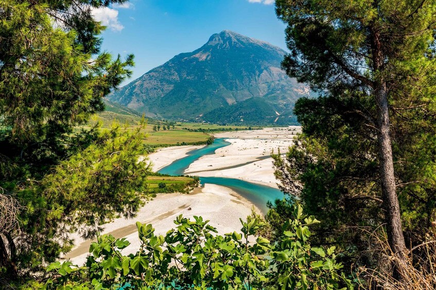 A river flowing through a valley with a mountain in the background. 2