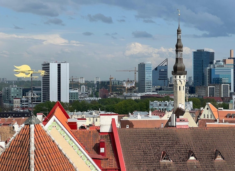 A cityscape with a prominent church tower, modern buildings, and a weather vane. 3