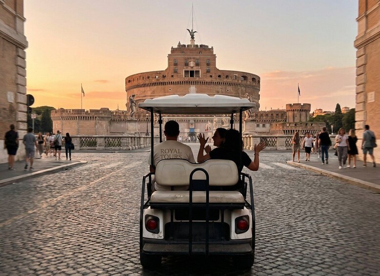 A couple in a golf cart with 'ROYAL TOURS' on the back, driving on a cobblestone street with the Colosseum in the background. 4