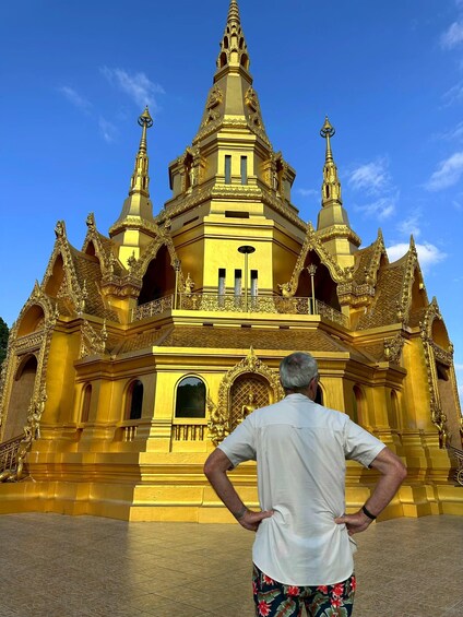A golden temple with intricate architecture and a clear blue sky. 5