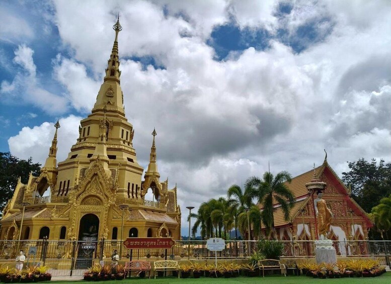 A golden temple with multiple spires and a smaller adjacent building with a red roof. 4