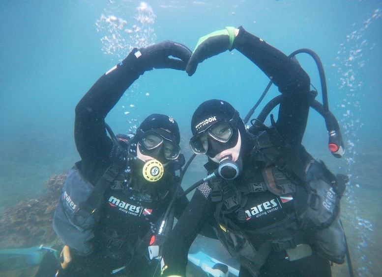 Two scuba divers forming a heart shape underwater, wearing 'mares diving center' gear. 5
