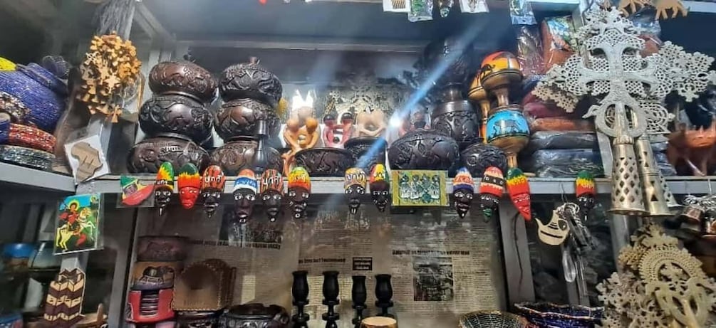 A variety of handcrafted items, including masks, pottery, and decorative objects. 3