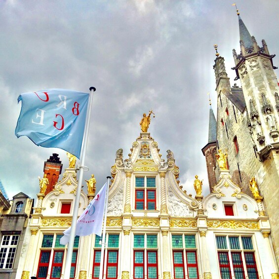 A historic building with ornate architecture, including statues and flags. 2