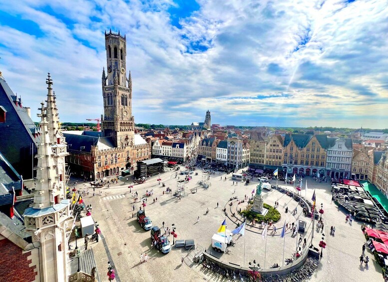 A historic square with a prominent tower, surrounded by traditional buildings and a clear sky. 3