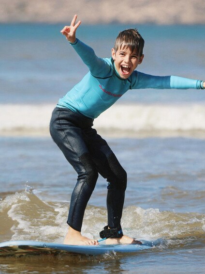 A child surfing on a wave at the beach. 2