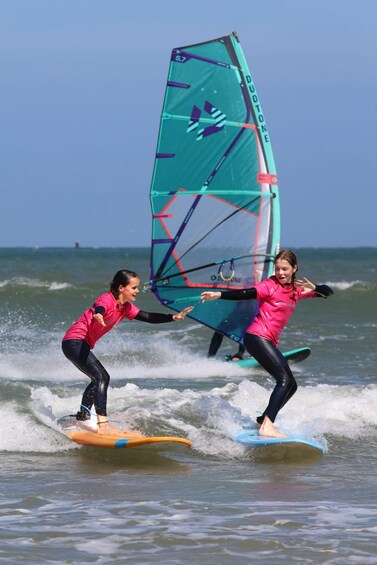 Two people windsurfing on a clear day. 1