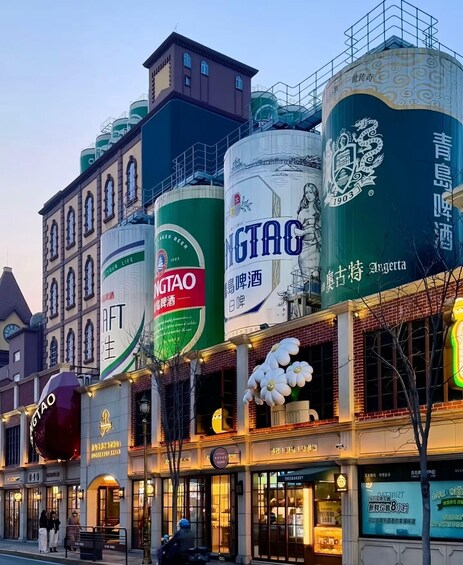 A street with buildings adorned with large beer advertisements. 3