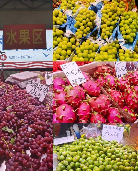 A fruit market with various fruits on display, including grapes, dragon fruits, and green apples. 2