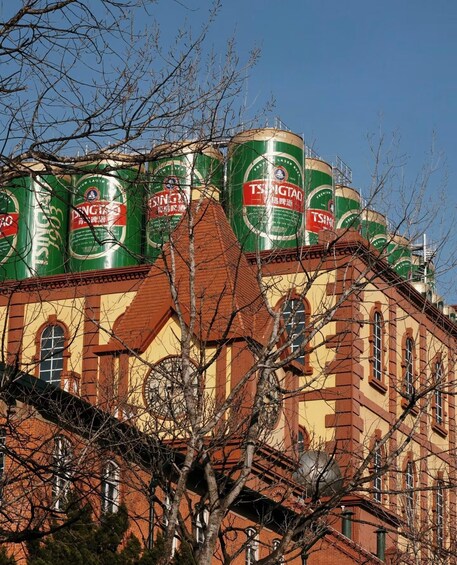 A building with green and red beer cans stacked on top. 5
