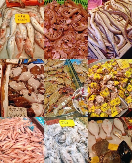A variety of seafood including fish, shrimp, and squid, displayed in a market setting with price tags. 4