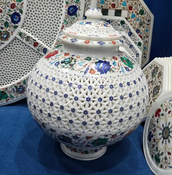 A white ceramic jug with blue floral patterns and a lid. 3