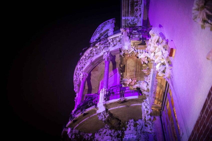 A building with ornate architectural details and a purple light. 5