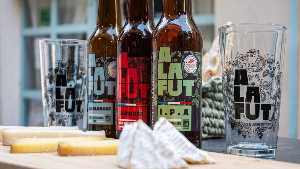 Bottles of La La Fut wine and cheese on a table. 1