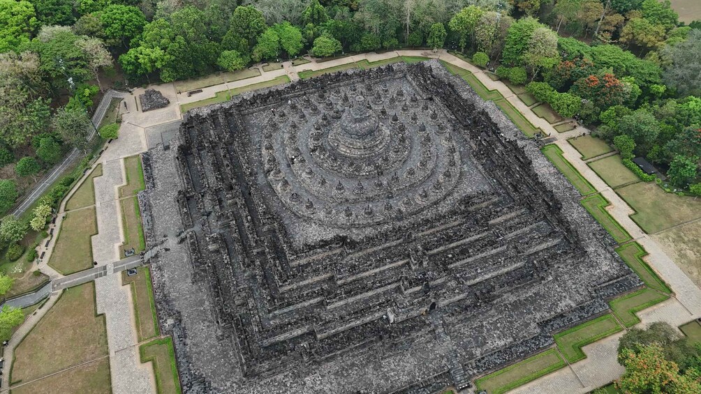An ancient temple complex with a central circular structure surrounded by smaller buildings. 4