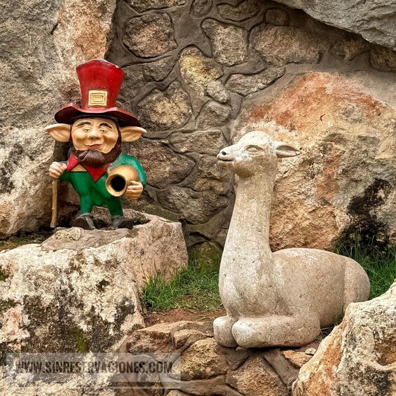 A statue of a leprechaun with a pipe and a goat statue. 5