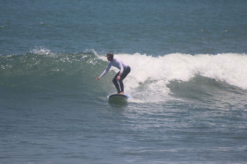 A person surfing a wave in the ocean. 2