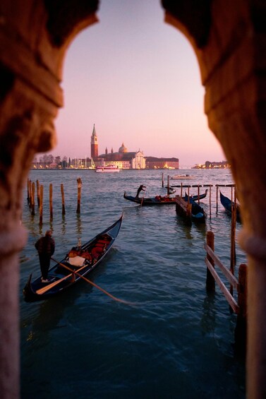 Gondolas on Venice's canals, a historic building, and a bridge in the background. 2