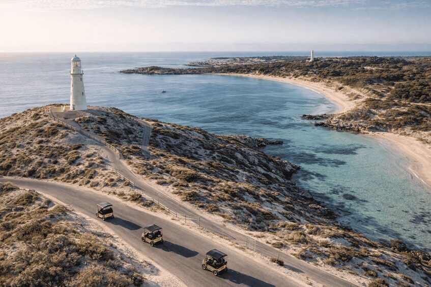 A coastal road with a lighthouse, a jeep, and a rocky landscape. 3
